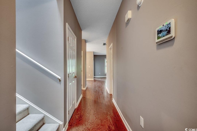 456 Colonial Trace Dr Unit 13-E, Longs, SC 29568 - hallway with wood finished floors, stairs, and a textured ceiling