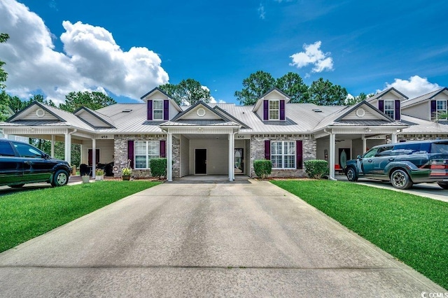 456 Colonial Trace Dr Unit 13-E, Longs, SC 29568 - townhome / multi-family property featuring a front lawn, concrete driveway, a metal roof, and an attached carport