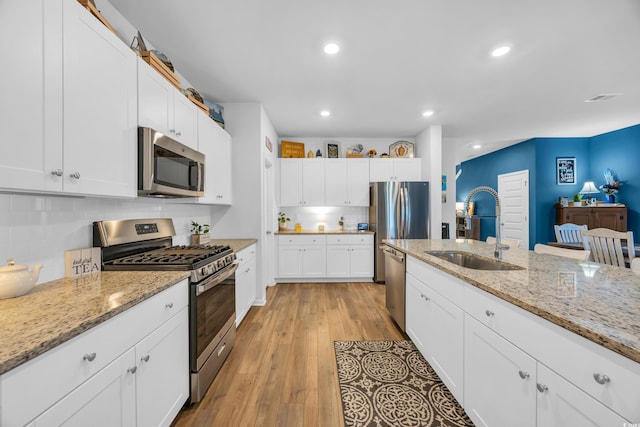 788 Dusty Pine Way, Myrtle Beach, SC 29588 - kitchen with stainless steel appliances, decorative backsplash, white cabinets, light wood-style flooring, and recessed lighting