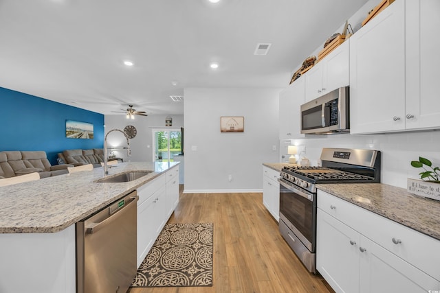 788 Dusty Pine Way, Myrtle Beach, SC 29588 - kitchen featuring appliances with stainless steel finishes, ceiling fan, white cabinets, open floor plan, and tasteful backsplash