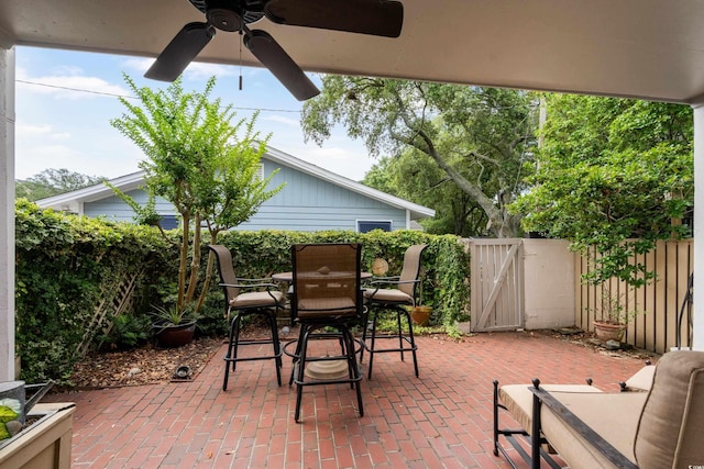 315 72nd Ave N Unit A, Myrtle Beach, SC 29572 - view of patio featuring a ceiling fan, a gate, and outdoor dining space