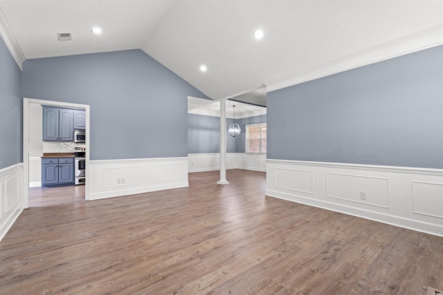 307 Russ Rd, Loris, SC 29569 - unfurnished room with ornamental molding, wainscoting, vaulted ceiling, a decorative wall, and a chandelier