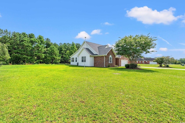 307 Russ Rd, Loris, SC 29569 - view of side of property with an attached garage, a lawn, and brick siding