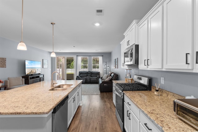 226 Calhoun Falls Dr, Myrtle Beach, SC 29579 - kitchen featuring stainless steel appliances, open floor plan, white cabinetry, dark wood-style flooring, and light stone countertops
