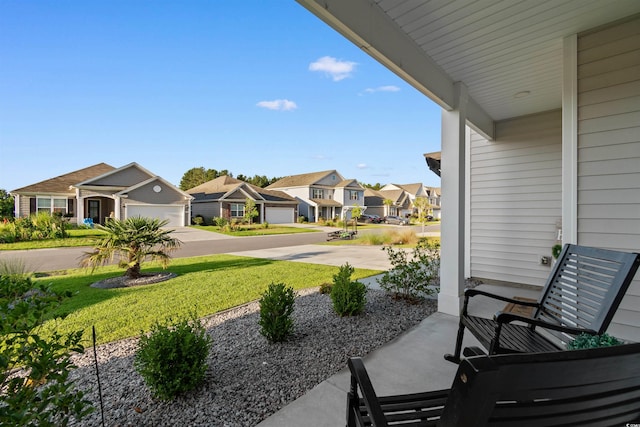 226 Calhoun Falls Dr, Myrtle Beach, SC 29579 - view of patio featuring a residential view, driveway, and a garage