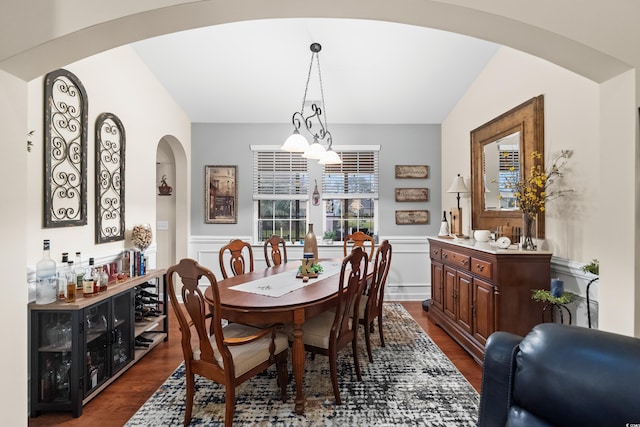 908 Ashbourn Ct, Murrells Inlet, SC 29576 - dining room with arched walkways, dark wood-type flooring, a wainscoted wall, and a decorative wall