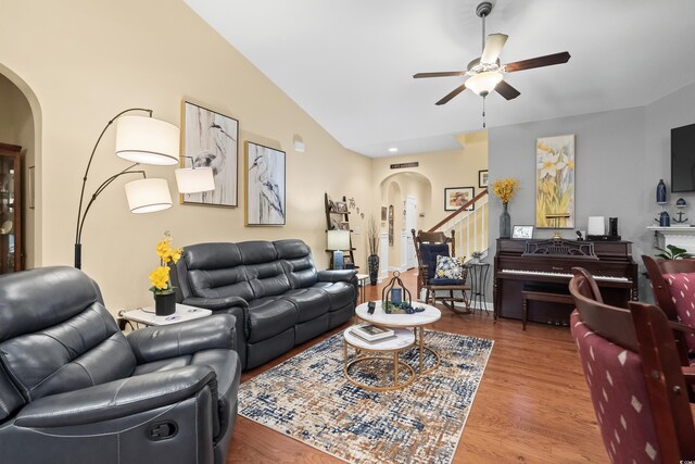 908 Ashbourn Ct, Murrells Inlet, SC 29576 - living room with arched walkways, ceiling fan, wood finished floors, stairs, and vaulted ceiling
