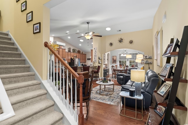 908 Ashbourn Ct, Murrells Inlet, SC 29576 - living room featuring arched walkways, a ceiling fan, wood finished floors, stairway, and lofted ceiling