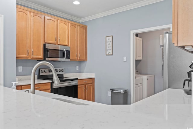 314 Black Oak Ln Unit 102, Murrells Inlet, SC 29576 - kitchen featuring appliances with stainless steel finishes, washer and dryer, crown molding, light stone countertops, and recessed lighting