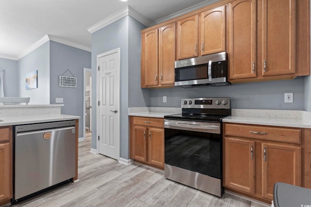 314 Black Oak Ln Unit 102, Murrells Inlet, SC 29576 - kitchen with stainless steel appliances, crown molding, light wood-style flooring, light countertops, and brown cabinetry