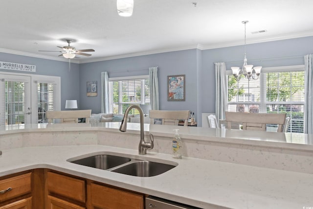 314 Black Oak Ln Unit 102, Murrells Inlet, SC 29576 - kitchen featuring hanging light fixtures, brown cabinetry, a chandelier, crown molding, and open floor plan