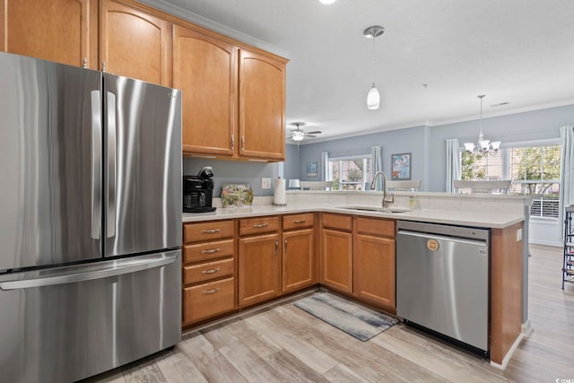 314 Black Oak Ln Unit 102, Murrells Inlet, SC 29576 - kitchen featuring stainless steel appliances, a peninsula, light countertops, light wood-type flooring, and healthy amount of natural light