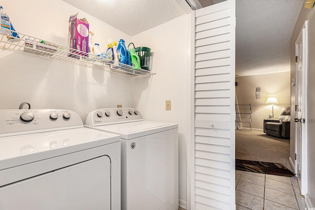951 Plantation Dr Unit F1, Little River, SC 29566 - laundry room with a textured ceiling, washer and dryer, light tile patterned floors, and light colored carpet