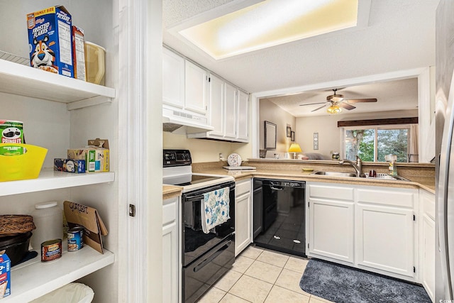 951 Plantation Dr Unit F1, Little River, SC 29566 - kitchen with black appliances, under cabinet range hood, light tile patterned flooring, white cabinets, and ceiling fan