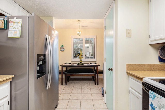 951 Plantation Dr Unit F1, Little River, SC 29566 - kitchen with stainless steel fridge with ice dispenser, white cabinetry, light countertops, electric range oven, and light tile patterned floors