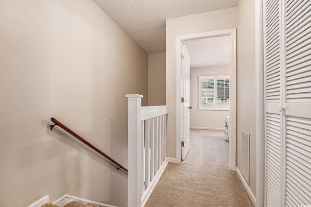 951 Plantation Dr Unit F1, Little River, SC 29566 - hallway featuring an upstairs landing, carpet flooring, and a textured ceiling