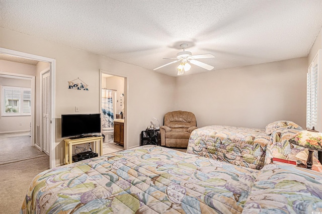 951 Plantation Dr Unit F1, Little River, SC 29566 - bedroom with light colored carpet, connected bathroom, a textured ceiling, and a ceiling fan