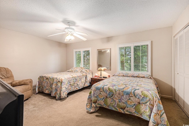 951 Plantation Dr Unit F1, Little River, SC 29566 - bedroom with carpet flooring, a closet, a ceiling fan, and a textured ceiling