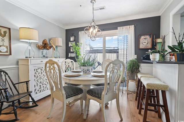 1710-C Edge Dr, North Myrtle Beach, SC 29582 - dining area featuring a chandelier, wainscoting, wood finished floors, and ornamental molding