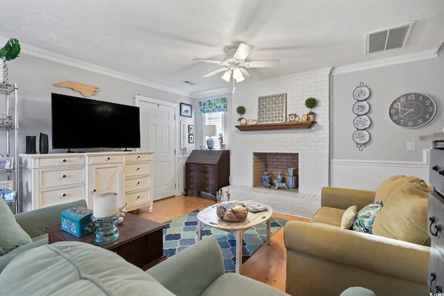 1710-C Edge Dr, North Myrtle Beach, SC 29582 - living area with a ceiling fan, light wood finished floors, ornamental molding, wainscoting, and a fireplace