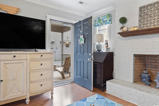 1710-C Edge Dr, North Myrtle Beach, SC 29582 - entryway with light wood-style flooring, ornamental molding, and a fireplace