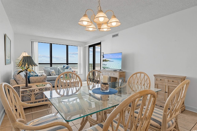 523 S Ocean Blvd Unit 305, North Myrtle Beach, SC 29582 - dining room featuring a chandelier, a textured ceiling, and light tile patterned floors
