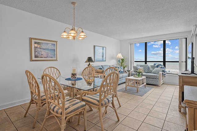 523 S Ocean Blvd Unit 305, North Myrtle Beach, SC 29582 - dining area with a textured ceiling, light tile patterned flooring, and a chandelier