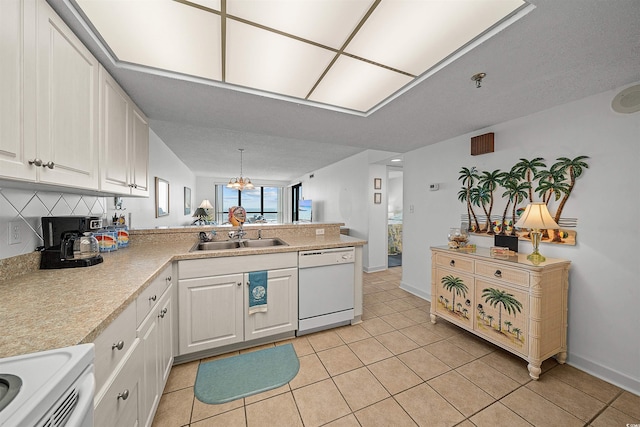 523 S Ocean Blvd Unit 305, North Myrtle Beach, SC 29582 - kitchen with white appliances, a peninsula, light tile patterned flooring, light countertops, and white cabinetry