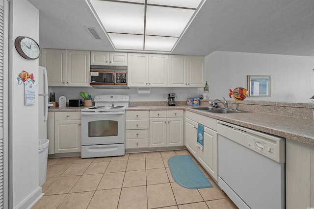 523 S Ocean Blvd Unit 305, North Myrtle Beach, SC 29582 - kitchen with white appliances, light tile patterned floors, light countertops, and a textured ceiling