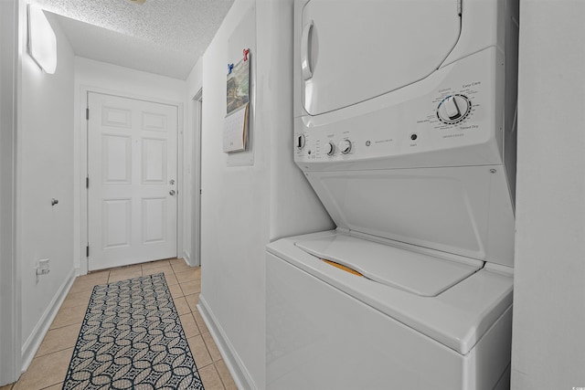 523 S Ocean Blvd Unit 305, North Myrtle Beach, SC 29582 - laundry room with stacked washer and clothes dryer, light tile patterned floors, and a textured ceiling