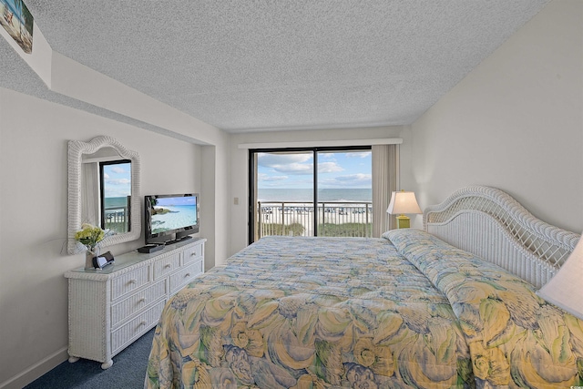 523 S Ocean Blvd Unit 305, North Myrtle Beach, SC 29582 - bedroom with access to exterior, dark carpet, and a textured ceiling