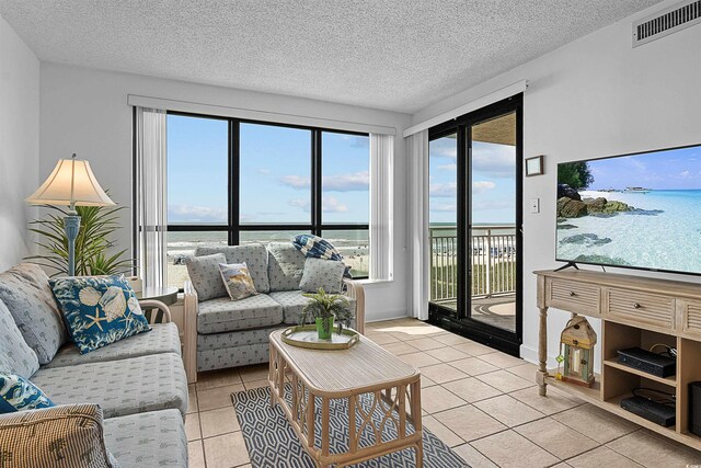 523 S Ocean Blvd Unit 305, North Myrtle Beach, SC 29582 - living area with light tile patterned floors and a textured ceiling