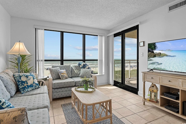 523 S Ocean Blvd Unit 305, North Myrtle Beach, SC 29582 - living area with light tile patterned floors and a textured ceiling