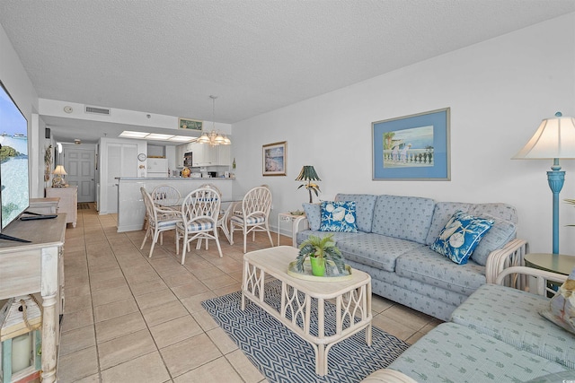 523 S Ocean Blvd Unit 305, North Myrtle Beach, SC 29582 - living area featuring a chandelier, light tile patterned flooring, and a textured ceiling