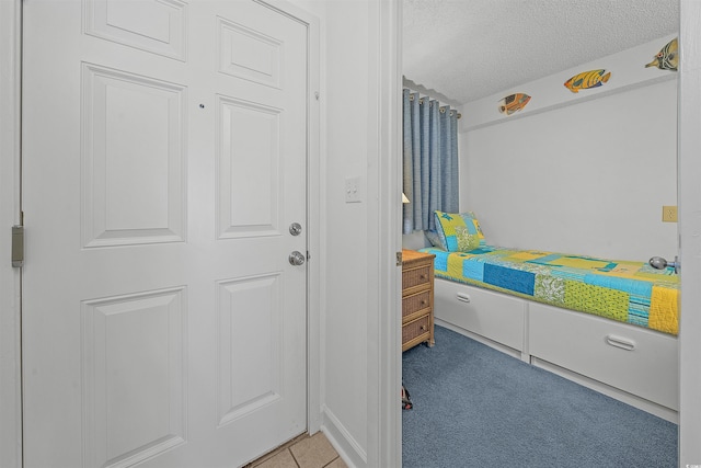 523 S Ocean Blvd Unit 305, North Myrtle Beach, SC 29582 - bedroom featuring a textured ceiling and light colored carpet