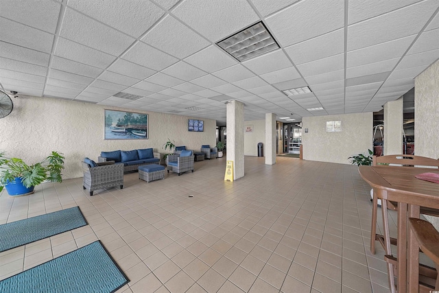 523 S Ocean Blvd Unit 305, North Myrtle Beach, SC 29582 - below grade area featuring a paneled ceiling, tile patterned flooring, and a textured wall