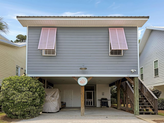 147 Weatherboard Ct, Pawleys Island, SC 29585 - rear view of property with a carport and stairs