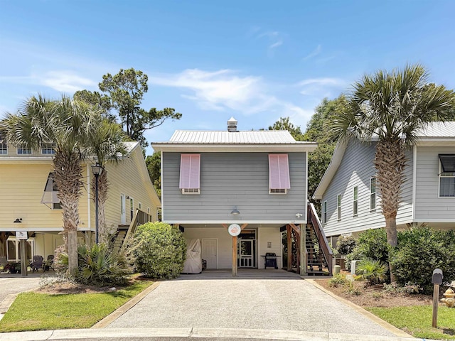 147 Weatherboard Ct, Pawleys Island, SC 29585 - coastal inspired home featuring a carport, stairs, driveway, and a metal roof