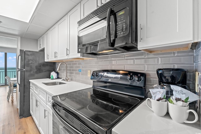 3000 N Ocean Blvd N Unit 1532, Myrtle Beach, SC 29577 - kitchen with range with electric cooktop, black microwave, and white cabinetry