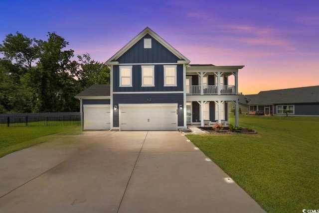 2212 Leeboard Ct, Myrtle Beach, SC 29579 - view of front facade featuring a balcony, board and batten siding, concrete driveway, a garage, and a porch