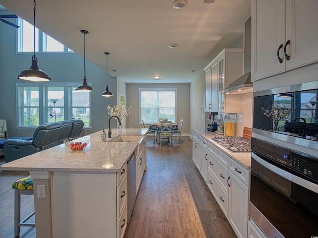376 Mikita Dr, Surfside Beach, SC 29575 - kitchen with appliances with stainless steel finishes, dark wood-style flooring, white cabinetry, light stone counters, and a breakfast bar