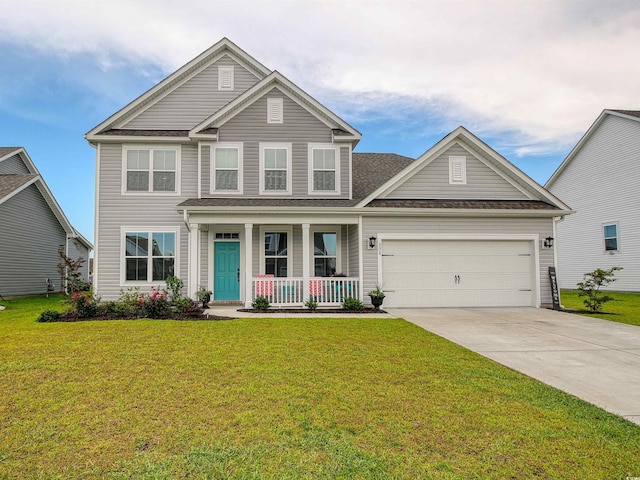 376 Mikita Dr, Surfside Beach, SC 29575 - view of front facade featuring covered porch, a garage, driveway, and a front yard