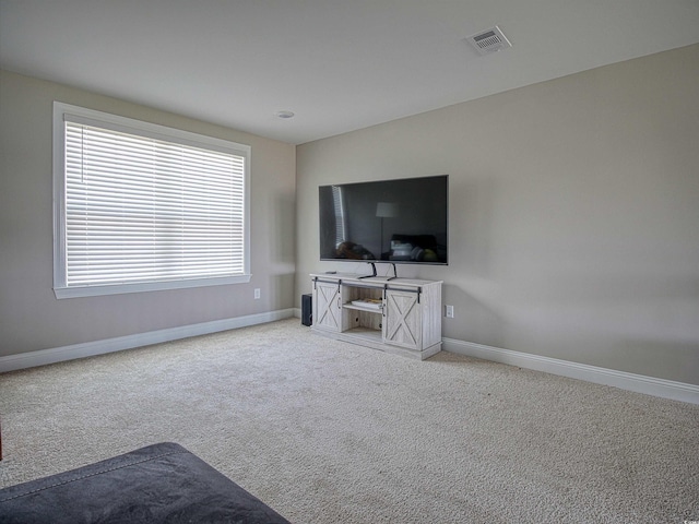 376 Mikita Dr, Surfside Beach, SC 29575 - unfurnished living room with baseboards and light colored carpet