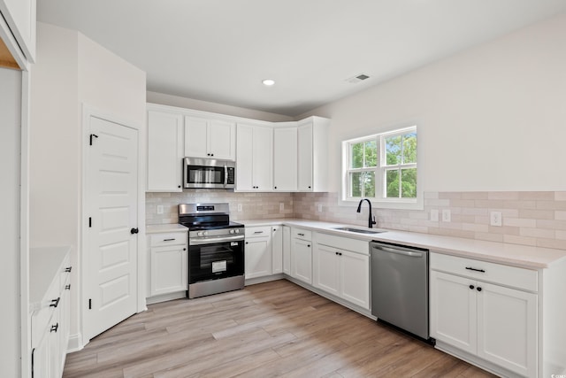 2428 Park St, North Myrtle Beach, SC 29582 - kitchen with stainless steel appliances, tasteful backsplash, white cabinets, light countertops, and recessed lighting