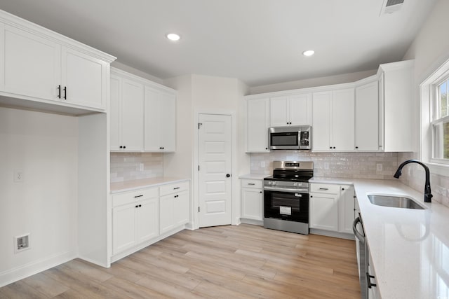 2428 Park St, North Myrtle Beach, SC 29582 - kitchen with stainless steel appliances, tasteful backsplash, white cabinets, recessed lighting, and light countertops