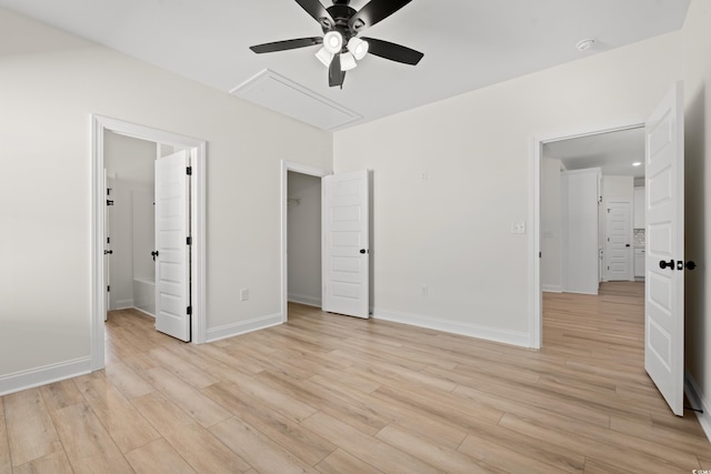 2428 Park St, North Myrtle Beach, SC 29582 - unfurnished bedroom featuring attic access, light wood-type flooring, a walk in closet, a ceiling fan, and ensuite bath