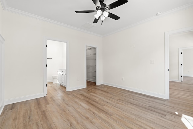 2428 Park St, North Myrtle Beach, SC 29582 - unfurnished bedroom with crown molding, a spacious closet, light wood finished floors, ensuite bath, and a closet