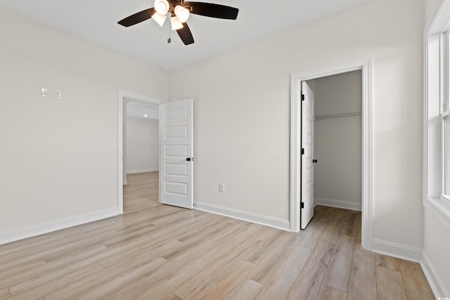 2428 Park St, North Myrtle Beach, SC 29582 - unfurnished bedroom with light wood-style floors, a spacious closet, a closet, and ceiling fan