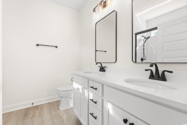 2428 Park St, North Myrtle Beach, SC 29582 - bathroom with double vanity, tiled shower, and wood finished floors