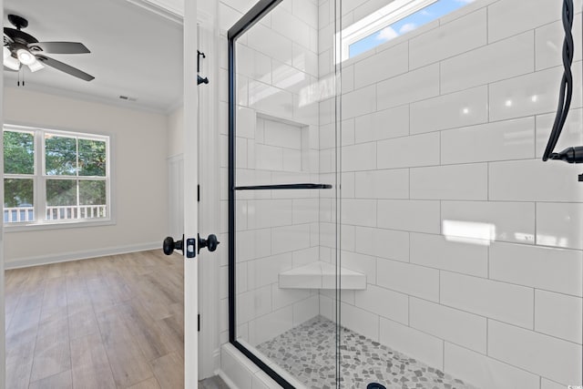 2428 Park St, North Myrtle Beach, SC 29582 - bathroom with crown molding, a ceiling fan, a stall shower, and wood finished floors